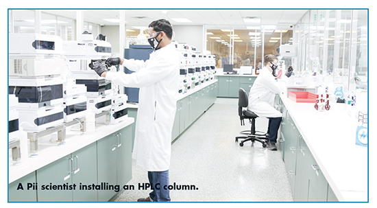 A Pii scientist installing an HPLC column.